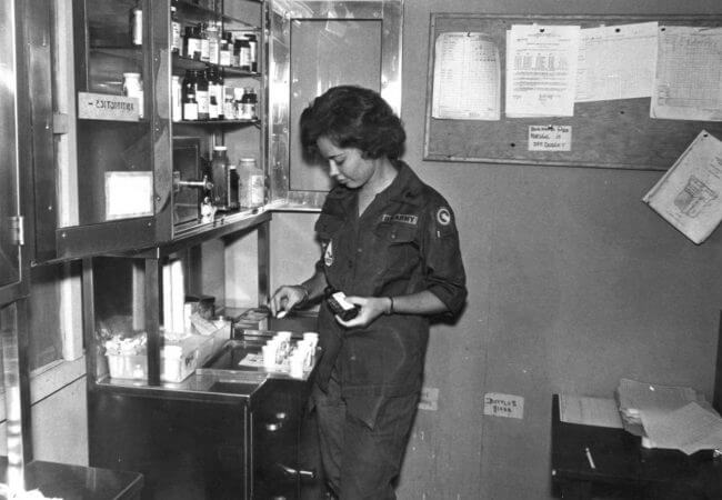 Karren Kowalski prepares medications for a patient in Bien Hoa, Vietnam in 1966.