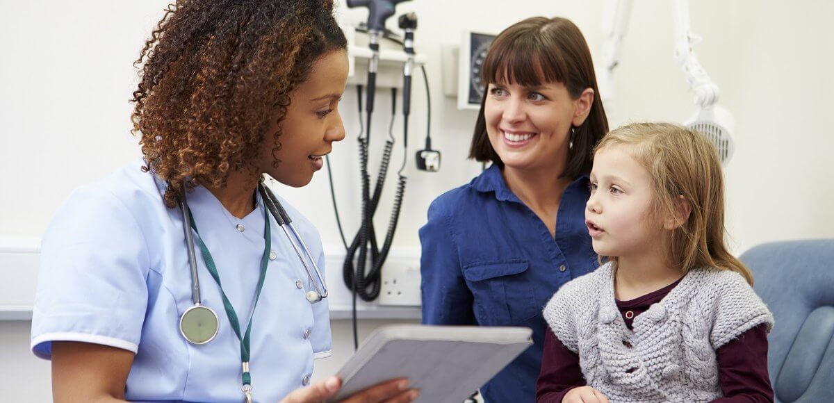 Nurse practitioner reviewing a chart with patients. 