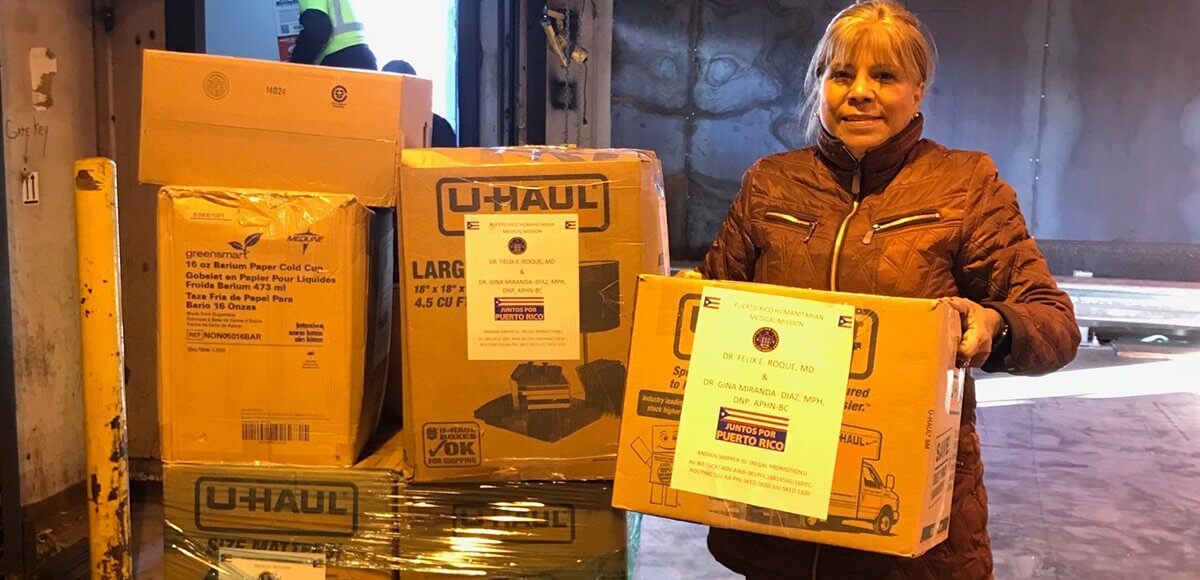 Humanitarian Gina Miranda-Diaz with packages sent to Puerto Rico