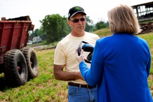 Marjorie McCullagh, PhD, RN, FAAOHN talks to farmer about how to protect farmers hearing.